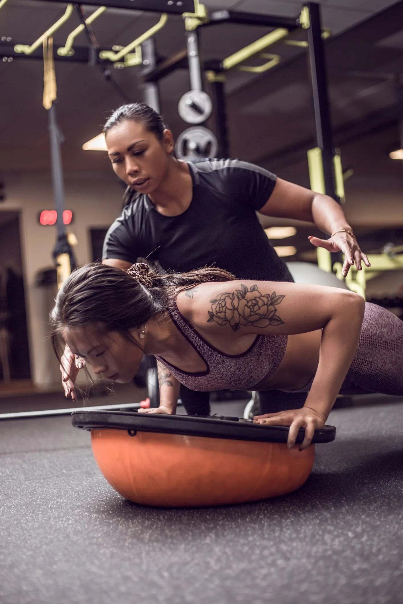 Personal trainer working with a client on fitness goals